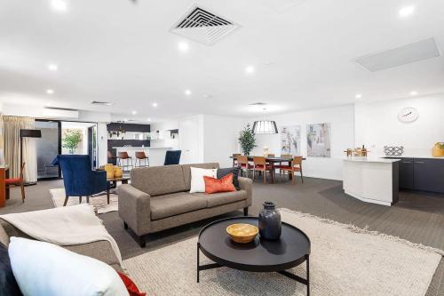a living room with a couch and a table at Large Luxe Penthouse fully equipped Perth CBD in Perth