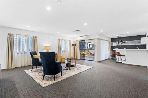 a living room with chairs and a dining room at Large Luxe Penthouse fully equipped Perth CBD in Perth