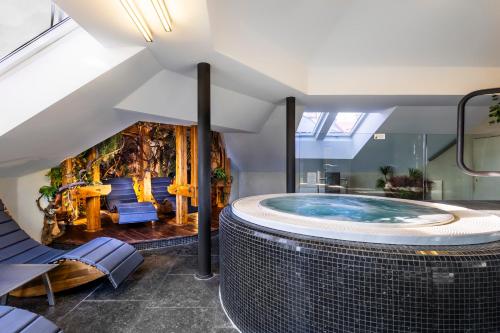 una gran bañera de hidromasaje en el medio de una habitación en Theresian Hotel en Olomouc