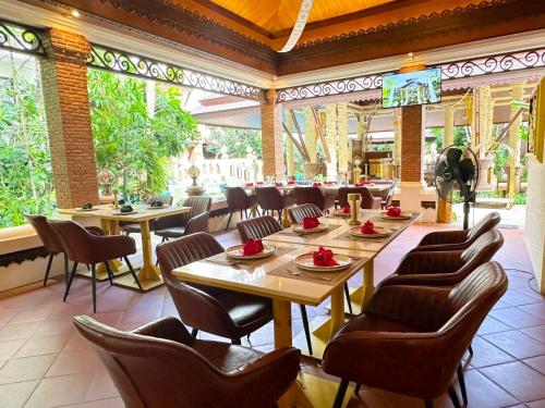 una sala da pranzo con tavoli e sedie in un ristorante di Quality Beach Resorts and Spa Patong a Patong Beach