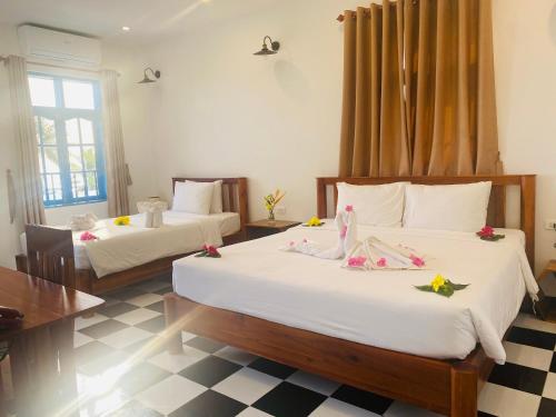 a bedroom with two beds with dolls on them at Vida Loca Sunset Beach Resort in Phu Quoc