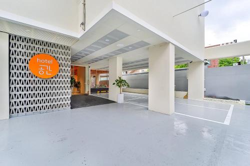 an empty lobby of a building with an orange sign on it at Gyeongju Hotel Gonggan in Gyeongju