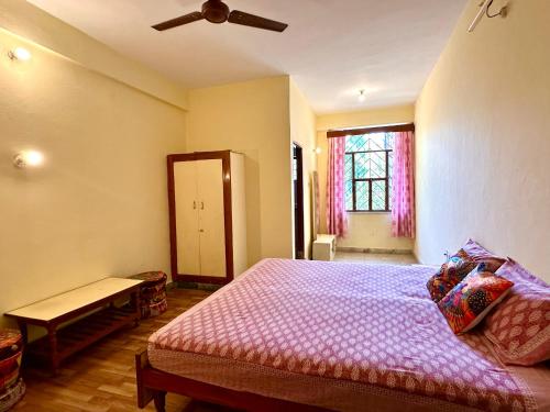 a bedroom with a bed and a ceiling fan at JWALA JAIPUR in Jaipur