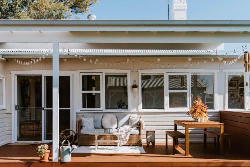 a screened in porch of a house with a table at The Cottage on Lawson - Heritage Elegance in Mudgee in Mudgee