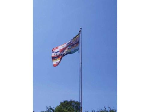 a flag flying on a pole in the sky at Jameln - Lüneburg Heath in Jameln