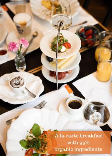 a table with white plates of food on it at Buxbaum Beletage Design & Boutique Hotel in Vienna