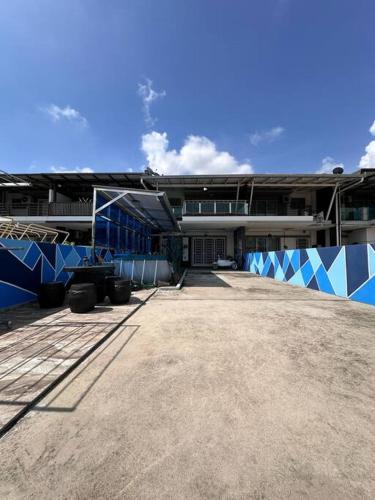 a large building with blue and white at H&H Homestay Premium House in Kepala Batas