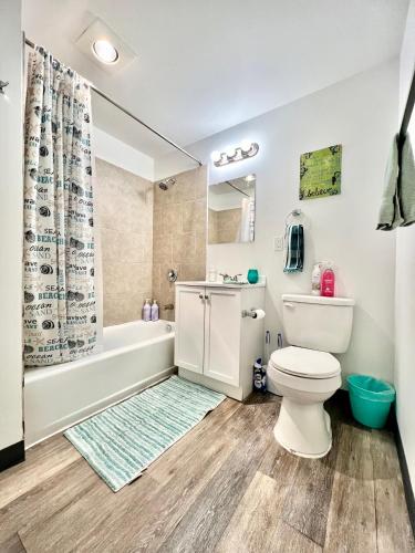 a bathroom with a toilet and a tub and a sink at Private Room with Shared Bathroom on the 1st Floor 10 Minutes Walk to University of Washington in Seattle