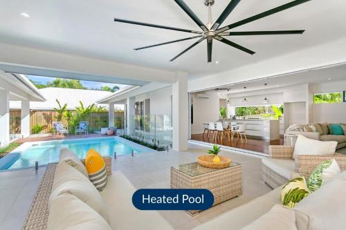 a living room with a heated pool in a house at Belle Escapes - Namaste, Oasis in Palm Cove in Palm Cove