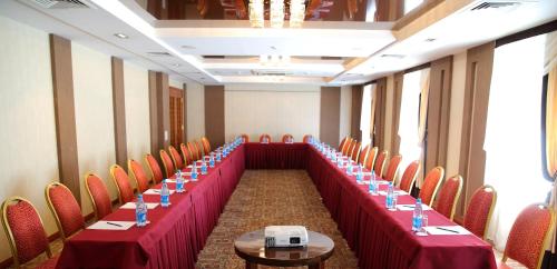 a long row of tables and chairs in a room at Park Hotel Bishkek in Bishkek