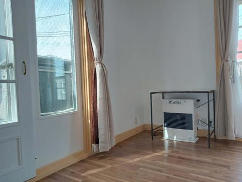 a room with a window and a computer on the floor at sakurayuki in Otaru