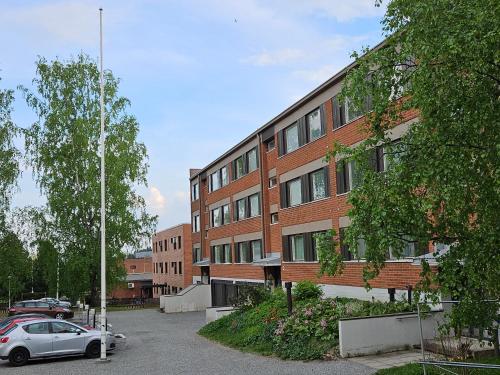 a car parked in front of a brick building at City Apartment with Lakeview in Iisalmi in Iisalmi