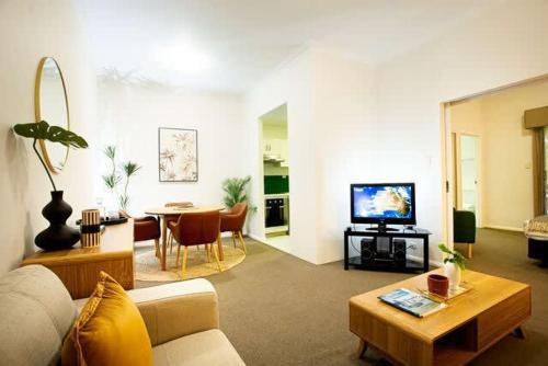 a living room with a couch and a table at Fully Renovated 1Bdr Apt in Northbridge in Perth