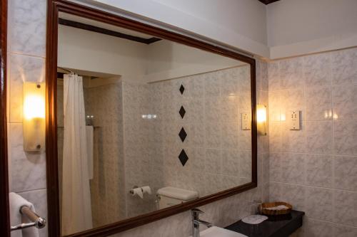 e bagno con specchio, servizi igienici e lavandino. di Hotel Boulevard Nairobi, City Centre CBD a Nairobi