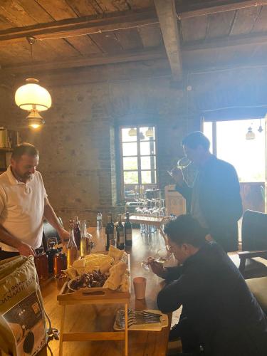 a group of men standing around a bar preparing food at Kardanakhi Estate in Anaga