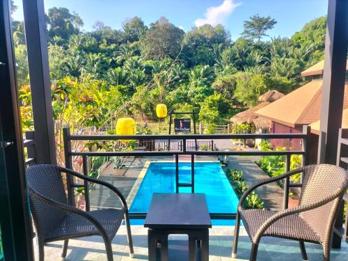 a view from the balcony of a resort with a swimming pool at Baan Koh Kwang Pool Villa Krabi in Krabi town