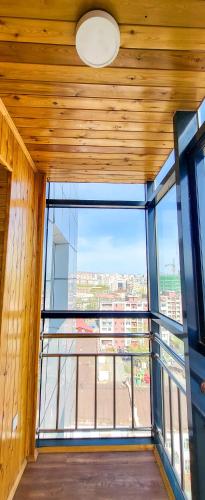 an empty room with a large window in a building at Mogul Tower Apartment, UB center in Ulaanbaatar