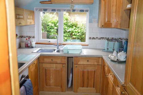 a kitchen with a sink and a window at Dawn in Hemsby