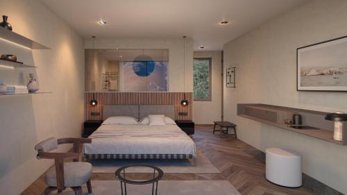 1 dormitorio con 1 cama y 1 silla en Exclusive Boutique Hotel Elisabetta, en Ronco sopra Ascona