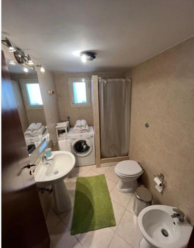 a bathroom with a sink and a toilet and a shower at Casa di Giò in Naples