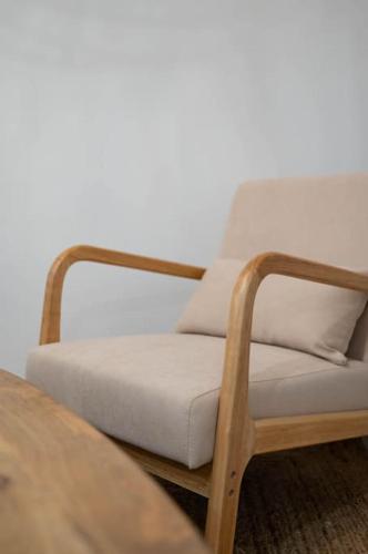 a wooden chair sitting next to a wooden table at La Madeleine, T2 Cœur Ville in Anse