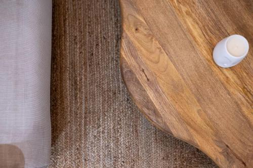 a wooden table with a white object on it at La Madeleine, T2 Cœur Ville in Anse