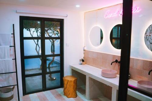 a bathroom with a sink and a mirror at PROMO! 2BRV With premium Pool in Uluwatu