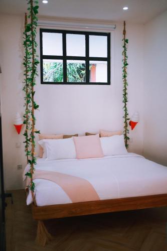 a bed in a room with a window at PROMO! 2BRV With premium Pool in Uluwatu