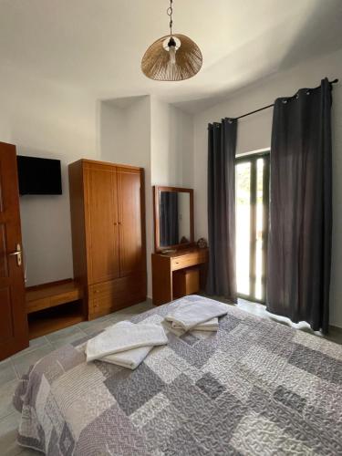 a bedroom with a bed with two towels on it at 4Seasons Sfakia in Khóra Sfakíon