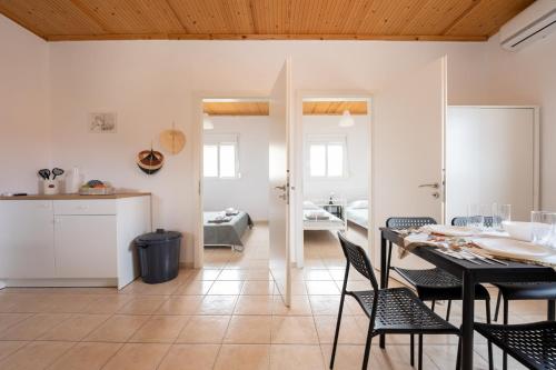 a kitchen and dining room with a table and chairs at Flegra House in Nea Potidaea