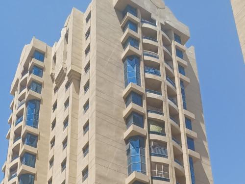 a tall building with windows on the side of it at Elegant Master Suite with Luxurious Compfort in Ajman 