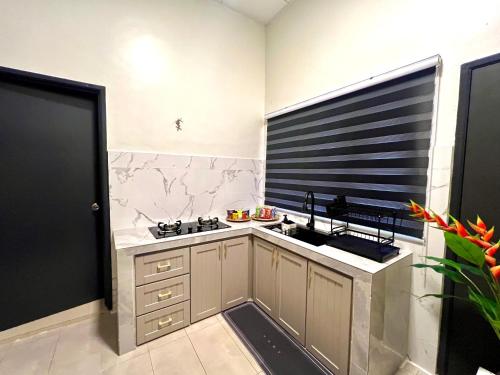 a kitchen with a sink and a window at Quayside Cove Homestay - Corner House, Shah Alam Rimbayu Netflix Syok TV BBQ in Shah Alam