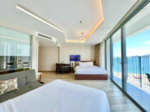a hotel room with a bed and a balcony at Panorama Nha Trang Condotel by One in Nha Trang