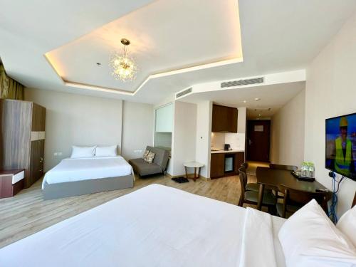 a hotel room with a bed and a desk at Panorama Nha Trang Condotel by One in Nha Trang
