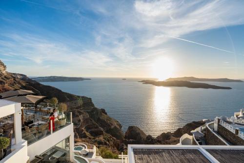 a view of the ocean from the balcony of a hotel at Petit Palace Suites in Fira