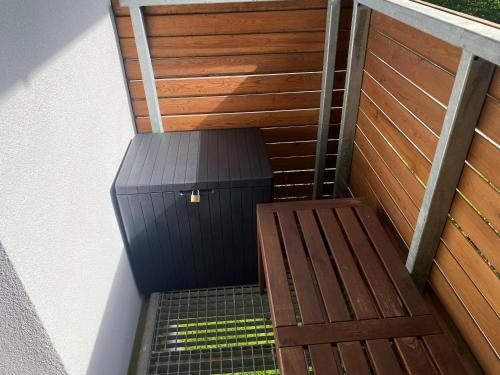 a stairway with a wooden door and a bench at Apartmány Vodohospodár in Mýto pod Ďumbierom
