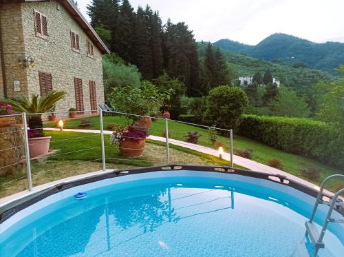 a swimming pool in the yard of a house at Villa Camelia Tuscany in Pescia