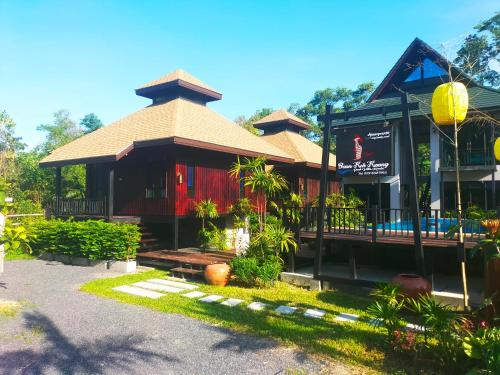 a building with a sign on the front of it at Baan Koh Kwang Pool Villa Krabi in Krabi town