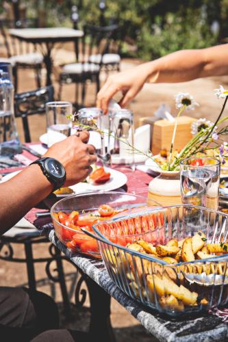 a group of people eating food on a table at Les Terrasses Himalayan Resort in Charikot
