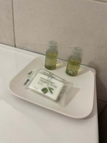 a toilettank with two bottles on top of it at CASA VACANZA IL FILATOIO appartamento Sophie in Castelletto sopra Ticino