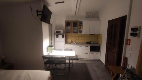 a small kitchen with a table and chairs in a room at By the Sea in Xiropótamon