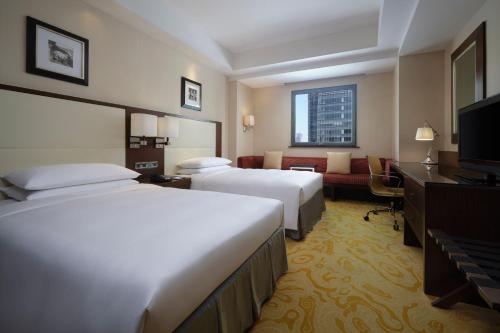 Postel nebo postele na pokoji v ubytování Courtyard By Marriott Shanghai Xujiahui