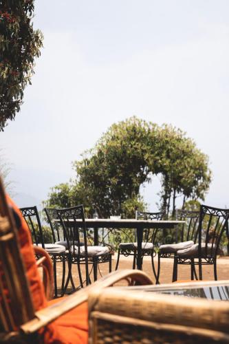 a group of chairs and a table and tables and chairs at Les Terrasses Himalayan Resort in Charikot