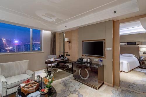 a hotel room with a bed and a television at Crowne Plaza Xi'an by IHG in Xi'an