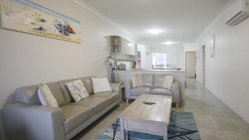 a living room with a couch and a coffee table at Apartment 5 - The Meridian in Old Bar