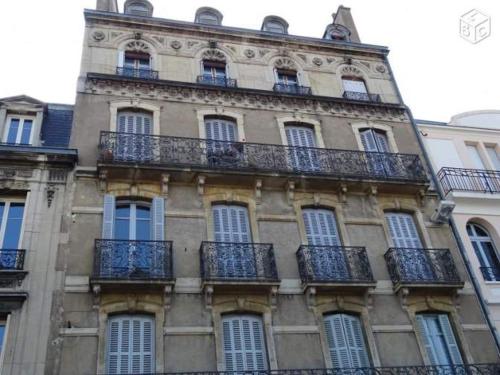 a tall building with balconies on the side of it at Studio au coeur du centre historique in Dijon