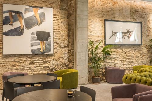 a restaurant with tables and chairs and artwork on the wall at Fetén in Valencia