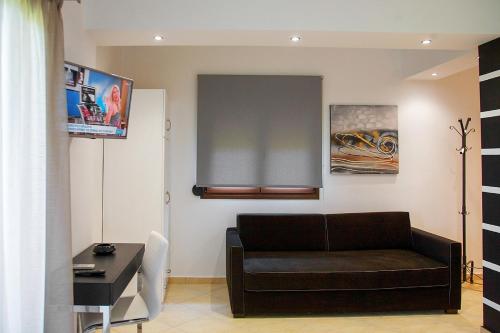 a living room with a couch and a table at studios ioanna in Vourvourou