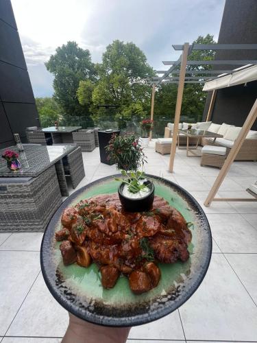 a plate of food on a table on a patio at Hotel Lantier Wellness & Spa in Bytom