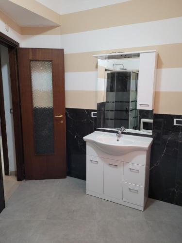 a bathroom with a white sink and a mirror at Casa Alessandro in Rapallo